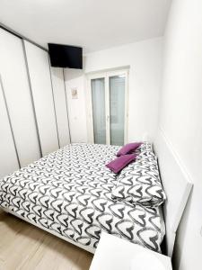 a bedroom with a bed with a purple pillow at Quela Apartment - Pietralata in Rome