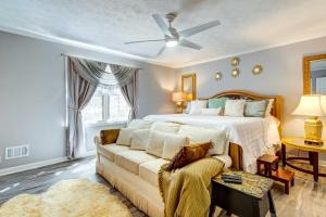 a bedroom with a bed and a couch at Lush Covington Home with Patio about 32 Mi to Atlanta! in Covington
