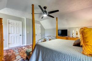 a bedroom with a bed with a ceiling fan at Lush Covington Home with Patio about 32 Mi to Atlanta! in Covington