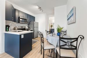 a kitchen and dining room with a table and chairs at U2 - Beachy Paradise -Private & Spacious 2bdrm apt in Hamilton