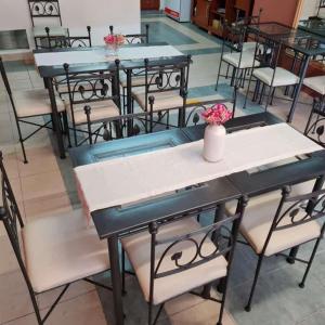 a group of tables and chairs with flowers on them at Hostal Alto Ayre Salta in Salta