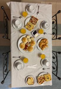 a table with plates of breakfast food on it at Hostal Alto Ayre Salta in Salta