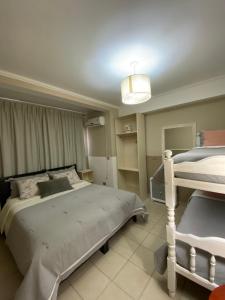 a bedroom with two bunk beds and a light at Hostal Alto Ayre Salta in Salta
