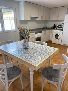 a kitchen with a table with a blue and white table at Casa Los Cuncos in Barrio de Lomba +14 photos