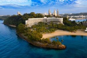 an island in the water with a hotel on it at Shangri-La Rasa Sentosa, Singapore in Singapore