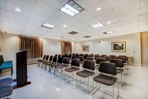 a conference room with chairs and a screen in it at Motel 6-Mesquite, TX - Balch Springs in Balch Springs +17 photos