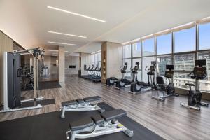 a gym with treadmills and cardio equipment in a building at Courtyard by Marriott Luoyang in Luoyang