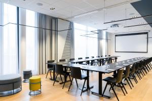 a conference room with a long table and chairs at Courtyard by Marriott Paris Creteil in Cr&eacute;teil