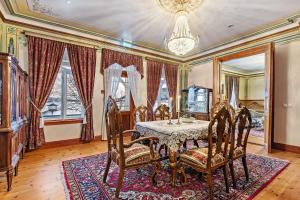 a dining room with a table and chairs and a chandelier at Sandtorgholmen Hotel - Best Western Signature Collection in Harstad