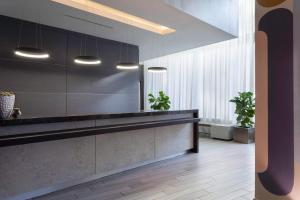 a kitchen with a counter and some potted plants at AC Hotel by Marriott Miami Beach in Miami Beach