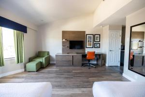 a hotel room with a desk and a chair at Days Inn by Wyndham Monterey Downtown in Monterey