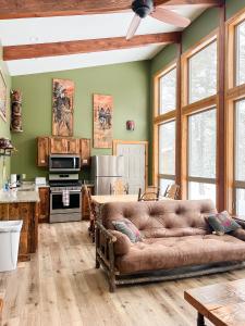 a living room with a couch and a kitchen at Cranberry Inn in Mercer