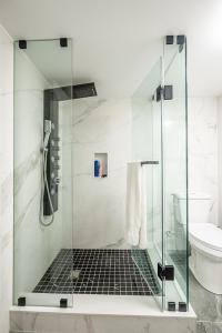 a bathroom with a glass shower with a toilet at Basement Master Bedroom in Mississauga