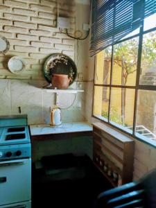 a small kitchen with a stove and a window at Casa Chica in Cafayate