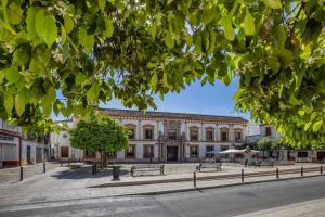 a large building with benches in front of it at Apartamento Al Alba in Córdoba