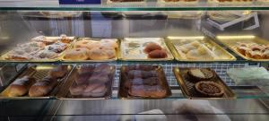 a display case filled with different types of donuts at Kalsa Sicilian Rooms in Partinico