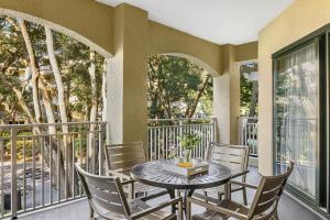 a patio with a table and chairs on a balcony at Marriott's Barony Beach Club in Hilton Head Island