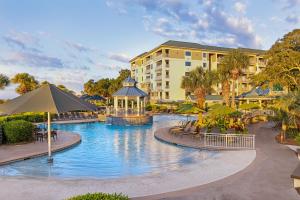 a resort pool with a gazebo and a building at Marriott's Barony Beach Club in Hilton Head Island