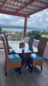 a dining table and chairs on a balcony at Apartamentos La Torre in Río San Juan