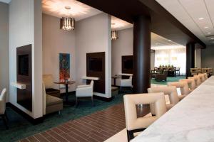 a lobby with chairs and tables and a waiting room at Residence Inn by Marriott Calgary South in Calgary