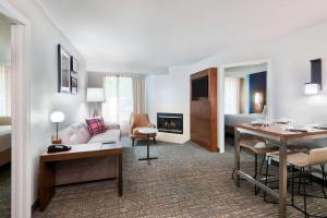 a hotel suite with a living room and a bedroom at Residence Inn by Marriott Sarasota Bradenton in Sarasota