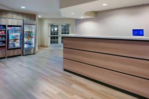 a lobby with a counter and refrigerators in a store at Residence Inn by Marriott Sarasota Bradenton in Sarasota