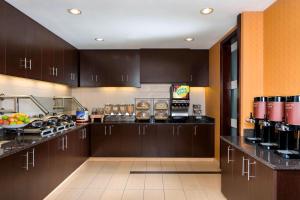 a large kitchen with brown cabinets and a counter top at Residence Inn by Marriott Fargo in Fargo