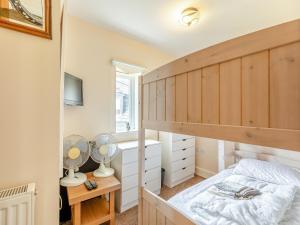 a bedroom with a bunk bed and a desk at Birch Cottage in Watchet