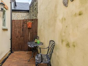 a small table and chairs sitting on a patio at Birch Cottage in Watchet