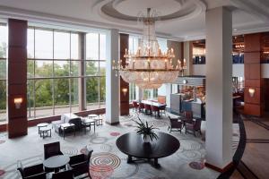 a large lobby with a chandelier and tables and chairs at Niagara Falls Marriott Fallsview Hotel & Spa in Niagara Falls