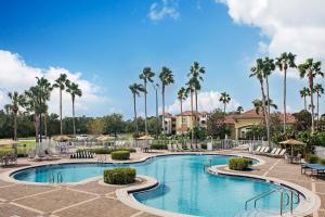 a swimming pool at a resort with palm trees at Sheraton PGA Vacation Resort Port St Lucie in Port Saint Lucie