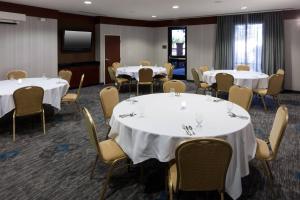 a conference room with white tables and chairs at Courtyard by Marriott Santa Clarita Valencia in Valencia