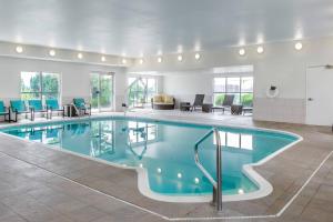a pool in a hotel room with chairs and tables at Residence Inn Denver North/Westminster in Westminster
