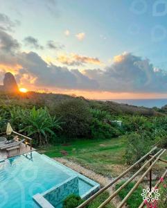 a swimming pool with a view of the ocean at Miragem Noronha in Fernando de Noronha