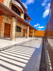 a building with shadows on the ground in front of it at Pousada Estrela Guia in Aparecida