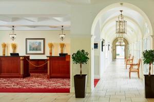 a hallway with a lobby with potted plants at Marriott's Village d'Ile-de-France in Bailly-Romainvilliers