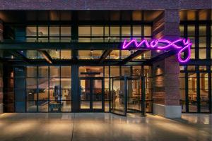 a neon sign on the side of a building at Moxy Brooklyn Williamsburg in Brooklyn