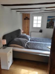 a large bed in a bedroom with a window at Ferienhaus Ehrbachklamm in Brodenbach