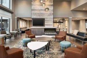 a lobby with a waiting area with chairs and a tv at Residence Inn by Marriott Minneapolis St. Paul/Eagan in Eagan