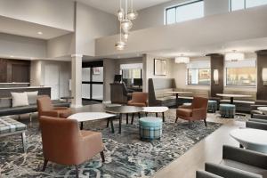 a lobby of a hotel with tables and chairs at Residence Inn by Marriott Minneapolis St. Paul/Eagan in Eagan