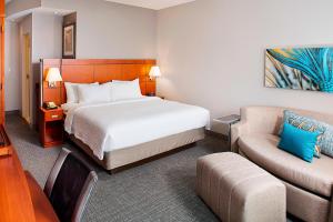 a hotel room with a bed and a couch at Courtyard by Marriott San Antonio SeaWorld®/Westover Hills in San Antonio
