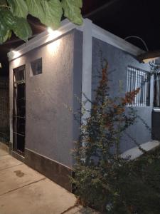 a building with a tree in front of it at FRIENDLY Studio in Maipú