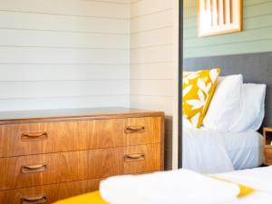 a bedroom with a dresser and a bed at The Cosy Cabin in Clapton in Gordano