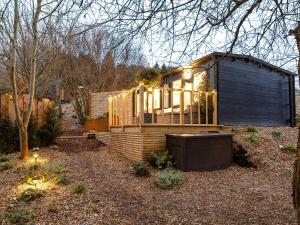 a tiny house with lights on the side of it at The Cosy Cabin in Clapton in Gordano