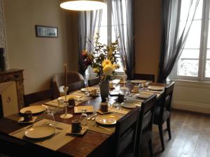 a dining room table with chairs and a long table at Maison Charles Maurice in Chalais