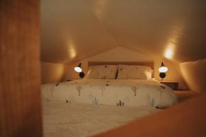 a bedroom with a bed with two lights on it at Agave Tiny House at Cactus Flower-HOT TUB-Pet Friendly-No Pet Fees! in Albuquerque