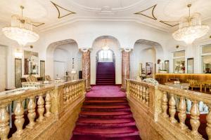 a staircase in a building with a purple carpet at Grand Hotel Bellevue - adults only in Merano