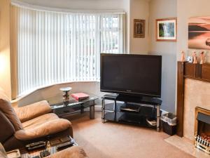 a living room with a large flat screen tv at Linden Cottage in York