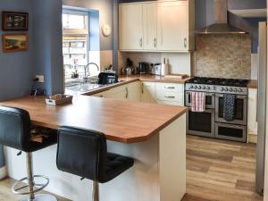 a kitchen with a wooden counter top in a room at Linden Cottage in York