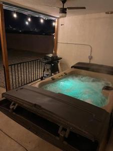 a hot tub with blue water in a room at Casa Charleston-3BR-2Bath-HOT TUB-Pet Friendly-No Pet Fees! in Albuquerque